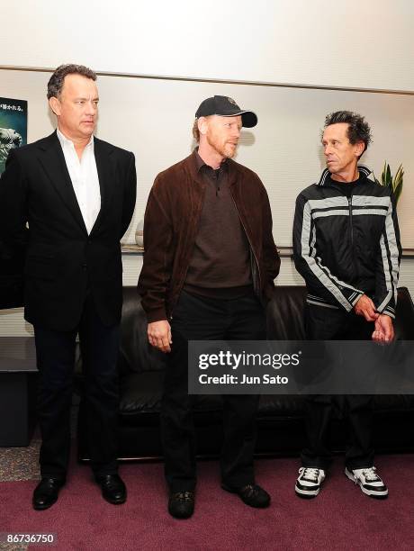 Actor Tom Hanks, director Ron Howard and producer Brian Grazer meet the press during the ceremonial first pitch prior to the professional baseball...