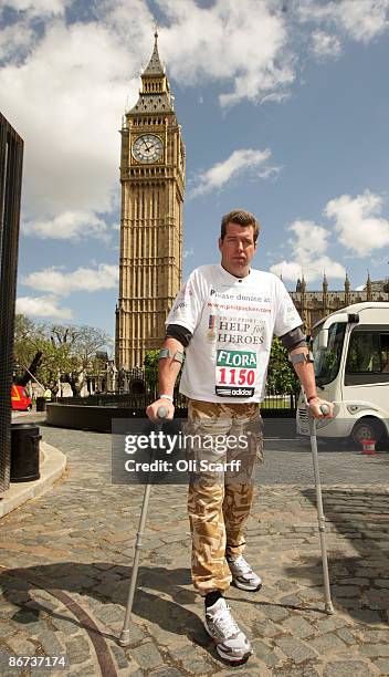 Phil Packer, who is walking the London Marathon, poses at the end of his penultimate day in front of Big Ben before entering the Houses of Parliament...