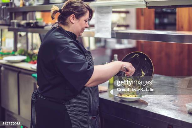 chef is working in an italian restaurant - baby octopus stock pictures, royalty-free photos & images