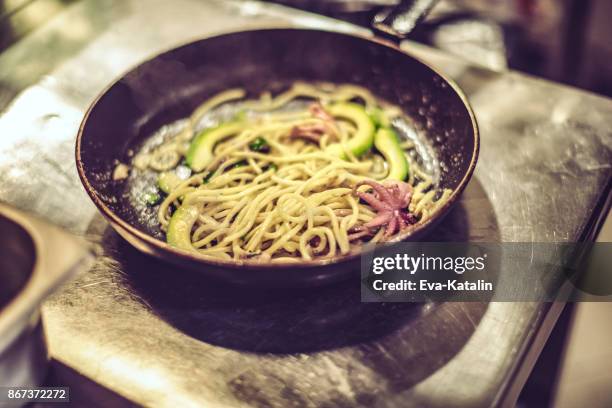 avocado spaghetti, baby octopus, pine nuts - baby octopus stock pictures, royalty-free photos & images