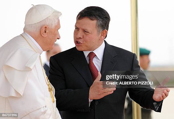 Jordan's King Abdullah II talks with Pope Benedict XVI upon his arrival at the International Queen Alia airport in Amman on May 8, 2009. Pope...