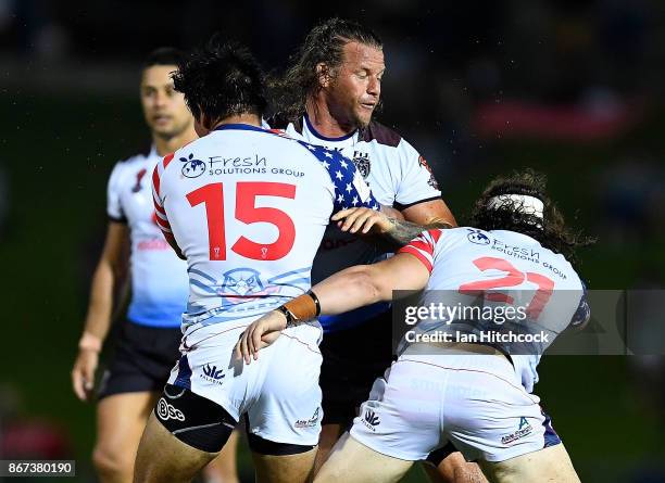 Ashton Sims of Fiji is tackled by Andrew Kneisly and Joshua Rice of the USA during the 2017 Rugby League World Cup match between Fiji and the United...