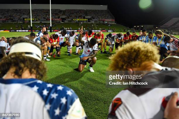 Kevin Naiqama of Fiji leads the two teams in a prayer at the end of the 2017 Rugby League World Cup match between Fiji and the United States on...