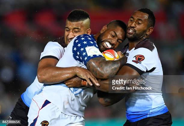 Eddy Pettybourne of the USA is tackled by Henry Raiwalui and Viliame Kikau of Fiji during the 2017 Rugby League World Cup match between Fiji and the...