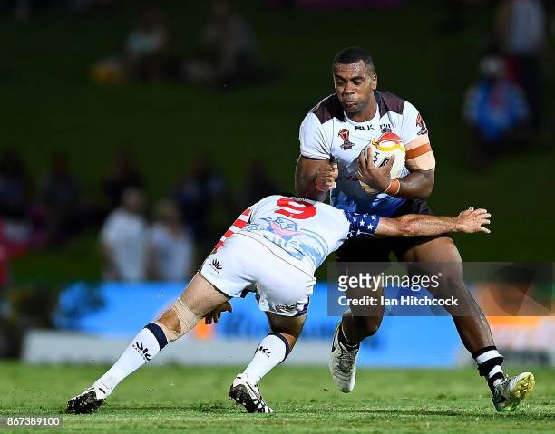 Petero Benjamin Nakubuwai of Fiji is tackled by David Marando of the USA during the 2017 Rugby League World Cup match between Fiji and the United...