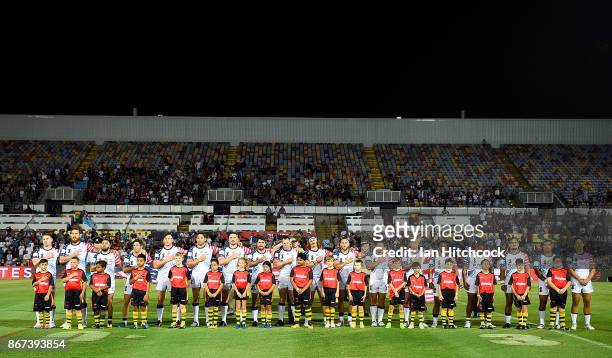 The USA team stand together for the national anthem before the start of the 2017 Rugby League World Cup match between Fiji and the United States on...