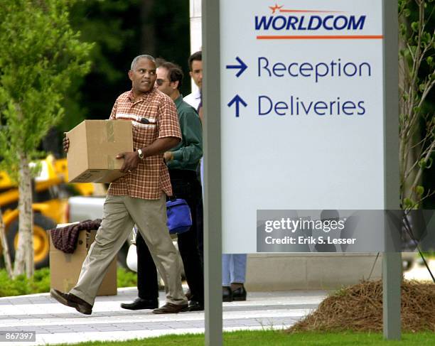 Employees leave the WorldCom building June 28, 2002 in Alpharetta, Georgia. About 17,000 workers at the financially troubled company are slated for...