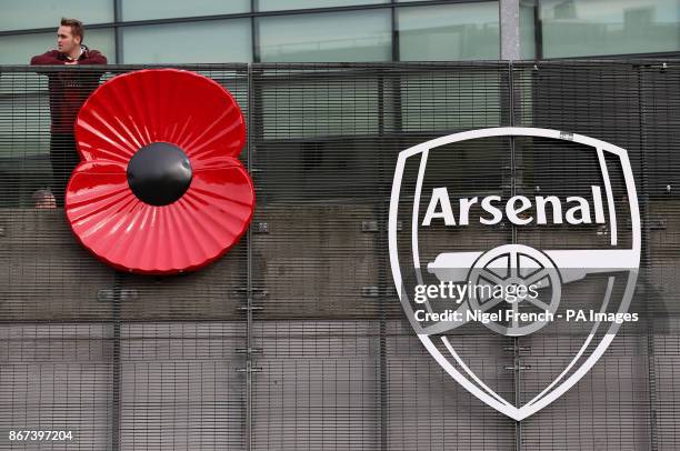 Giant poppy next to an Arsenal logo during the Premier League match at the Emirates Stadium, London.