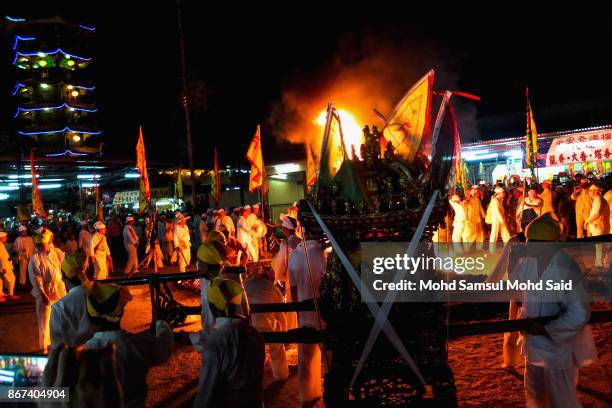Malaysians of Chinese descent walk on burning charcoals during the last day of Chinese Nine Emperor Gods Festival inside the temple on October 28,...