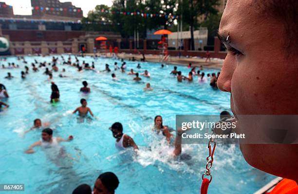 Lifeguard Dennis Rodriguez keeps on eye on swimmers June 28, 2002 on the opening day of New York City's public pools. With a week of temperatures in...