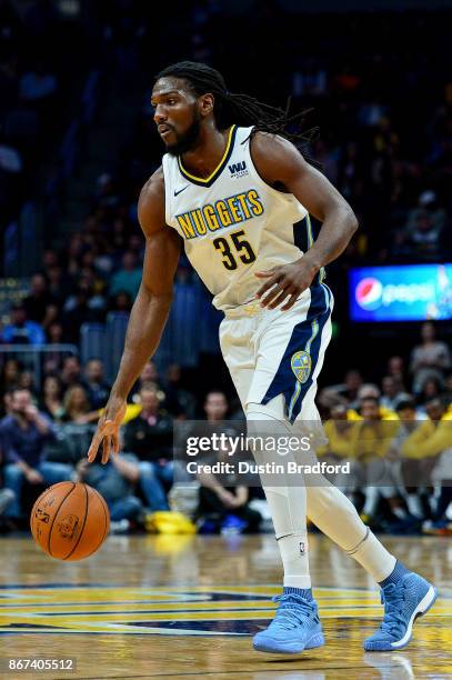 Kenneth Faried of the Denver Nuggets dribbles against the Washington Wizards during an NBA game at the Pepsi Center on October 23, 2017 in Denver,...