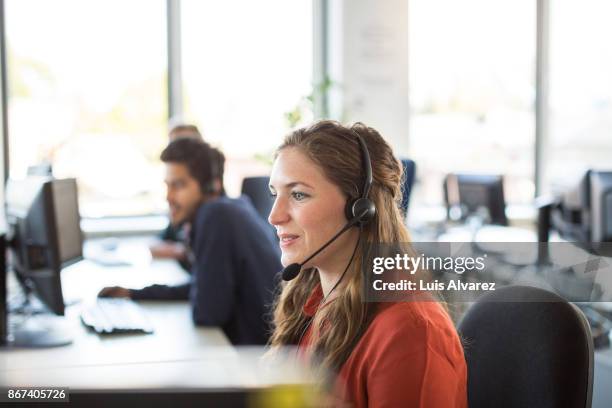 female customer representative working in office - opérateur téléphonique photos et images de collection