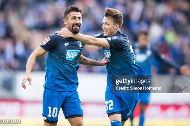 Kerem Demirbay of Hoffenheim celebrates his team's first goal with team mate Dennis Geiger during the Bundesliga match between TSG 1899 Hoffenheim...