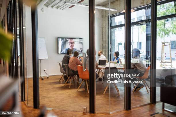 Business people video conferencing in board room