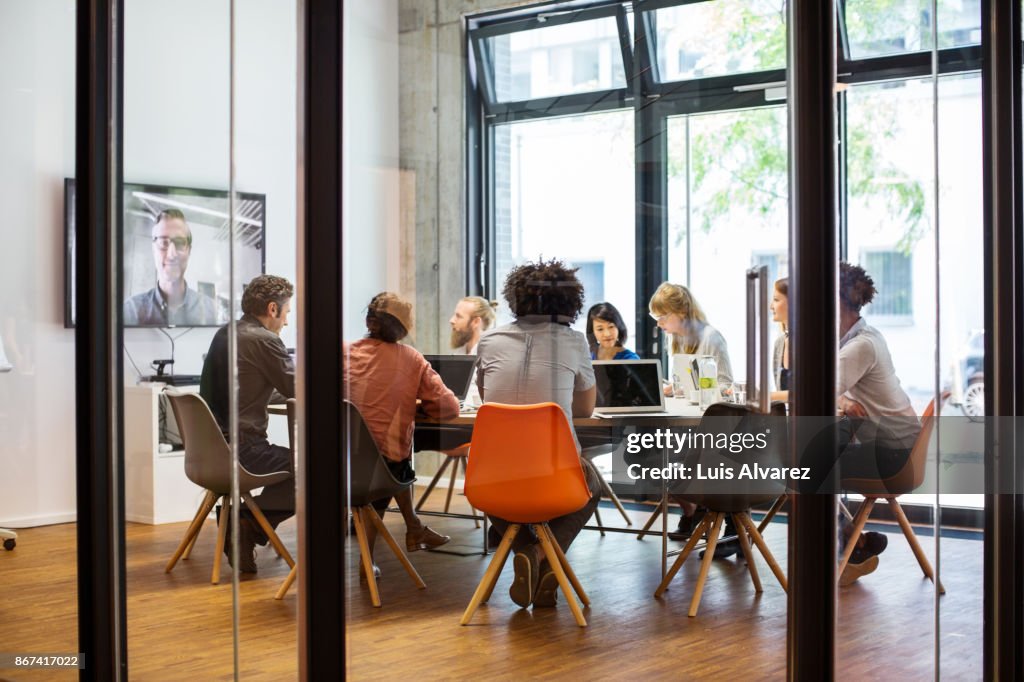 Business people video conferencing in office