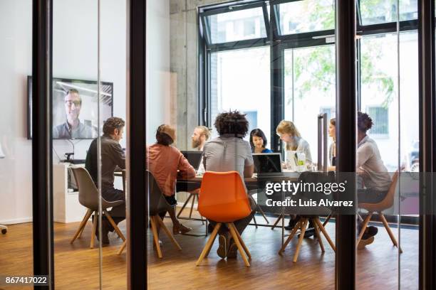 business people video conferencing in office - meeting room stock pictures, royalty-free photos & images