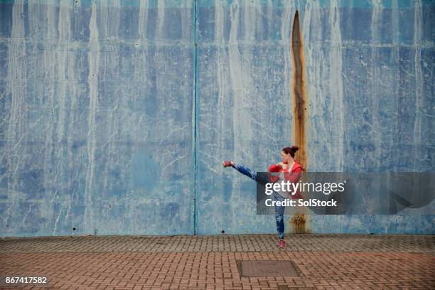 mature woman trianing outdoors - kickboxing stock pictures, royalty-free photos & images