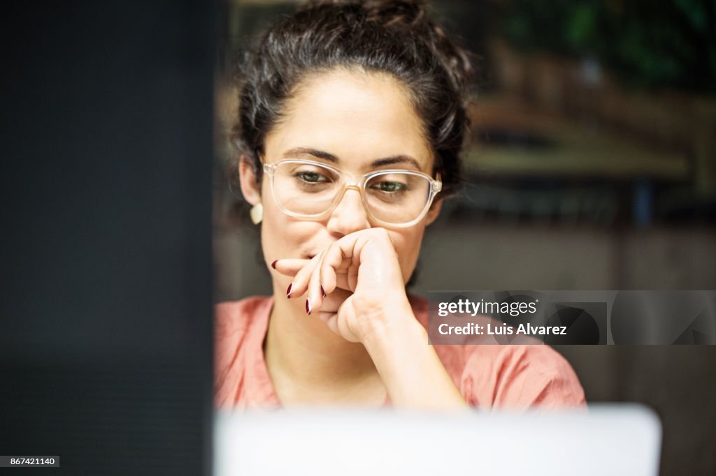 Thoughtful businesswoman using computer in office