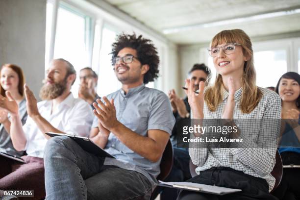 confident businesswoman and colleagues applauding during meeting - clapping stock pictures, royalty-free photos & images