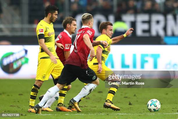 Nuri Sahin of Dortmund, Oliver Sorg of Hannover, Felix Klaus of Hannover and Mario Goetze of Dortmund fight for the ball during the Bundesliga match...