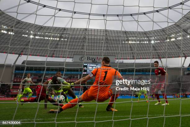 Beyhan Ametov of Koeln scores his team's first goal past Bernd Leno goalkeeper of Leverkusen to make it 0-1 during the Bundesliga match between Bayer...