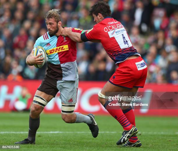 Chris Robshaw of Harlequins is tackled by Donncha O'Callaghan of Worcester Warriors during the Aviva Premiership match between Harlequins and...