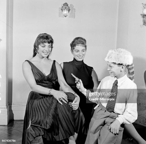 Joan Collins, actress, aged 22, pictured wearing black silk cocktail dress, at her flat in Marylebone, London, 10th February 1954. Photo-call after...