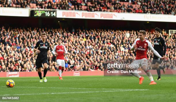Aaron Ramsey of Arsenal scores his sides second goal during the Premier League match between Arsenal and Swansea City at Emirates Stadium on October...