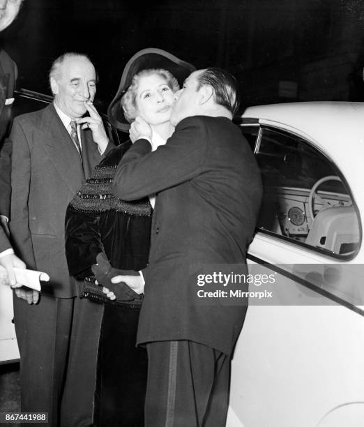 Billy Hill kissing goodnight to Lady Docker after she left his party which he threw on the launching of his book. Also in the picture is Sir Bernard...