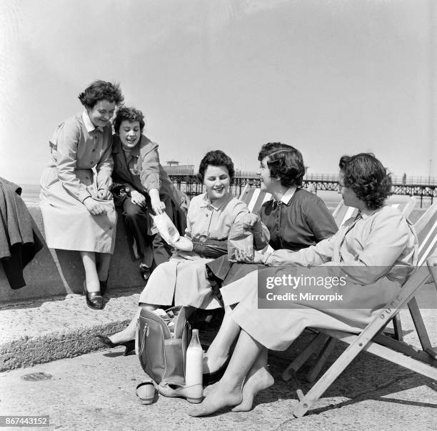 These young ladies from Rhyl decided to have a picnic lunch on the prom in the lovely sunshine which bathed the town all day. They are - Barbara...