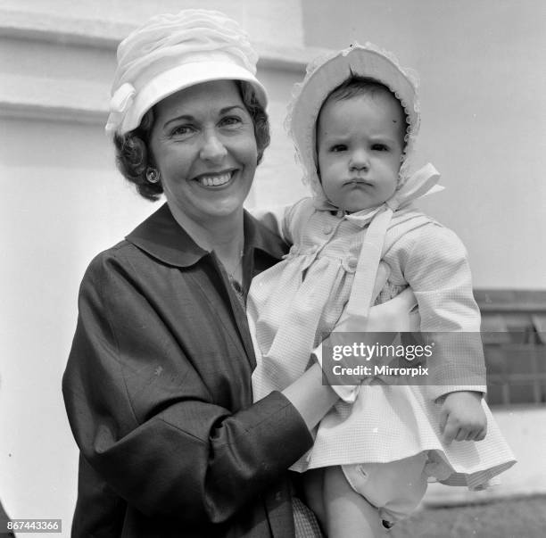 Barbara Riese, pictured with their daughter Penny who is 8 months old as this picture was taken. They are pictured arriving at London Airport....