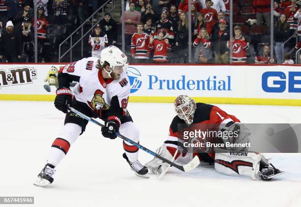 Keith Kinkaid of the New Jersey Devils makes the save on Mike Hoffman of the Ottawa Senators at the Prudential Center on October 27, 2017 in Newark,...