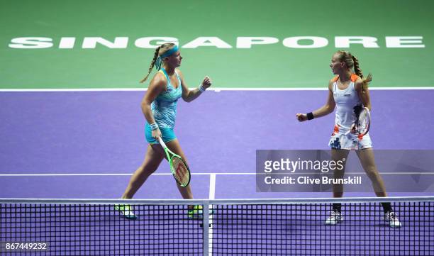 Kiki Bertens of Netherlands and Johanna Larsson of Sweden celebrate a point in the doubles semi final match against Elena Vesnina and Ekaterina...