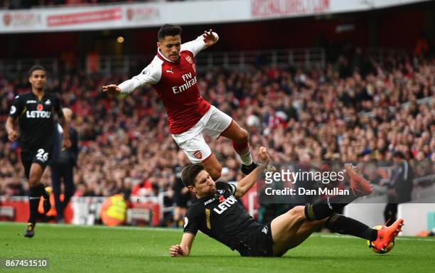 Federico Fernandez of Swansea City tackles Alexis Sanchez of Arsenal during the Premier League match between Arsenal and Swansea City at Emirates...