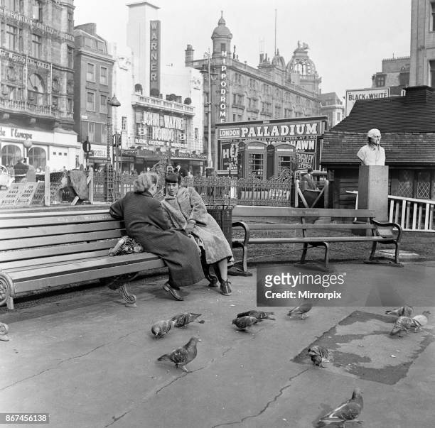 Feeding birds in Leicester Square, London, during lunch hour, 8th March 1954.