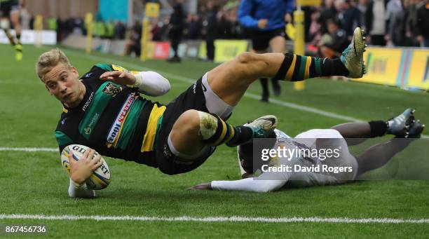 Harry Mallinder of Northampton dives over for a try during the Aviva Premiership match between Northampton Saints and Wasps at Franklin's Gardens on...