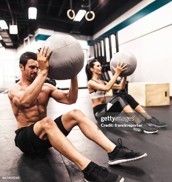 coach doing abs with the medicine ball - absinto stock pictures, royalty-free photos & images