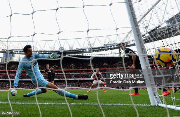 Aaron Ramsey of Arsenal scores his sides second goal past Lukasz Fabianski of Swansea City during the Premier League match between Arsenal and...