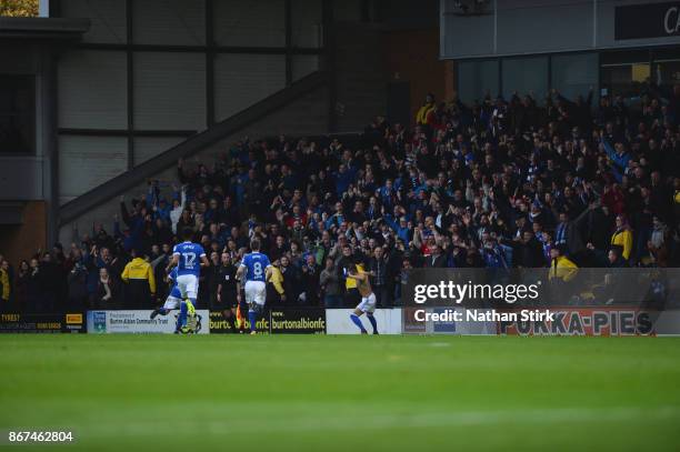 Bersant Celina of Ipswich throws his shirt into the crowd after scoring the winner during the Sky Bet Championship match between Burton Albion and...