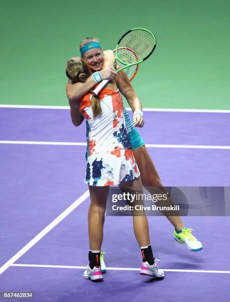 Kiki Bertens of Netherlands and Johanna Larsson of Sweden celebrate victory in the doubles semi final match against Elena Vesnina and Ekaterina...