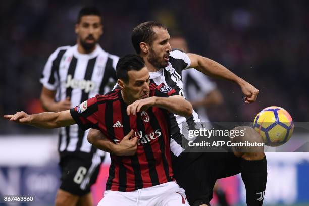 Milan's forward Nikola Kalinic from Croatia fights for the ball with Juventus' defender Giorgio Chiellini during the Italian Serie A football match...