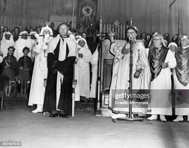 The chaired bard, T Llew Jones of Llandysul, stands while the sword of peace ceremony is carried out. The Eisteddfod, Ebbw Vale, 8th August 1958.