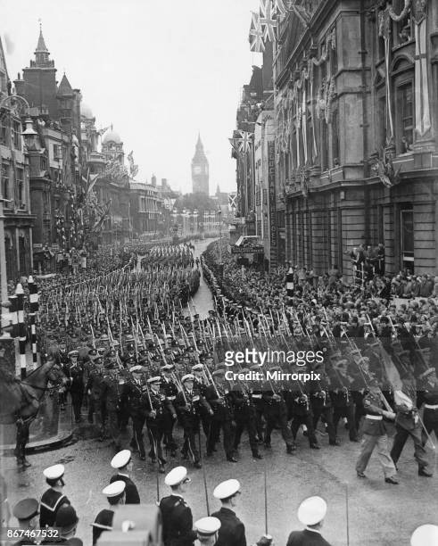 Members of overseas armed services march along Whitehall leading the coronation procession back to Buckingham Palace following the coronation of...