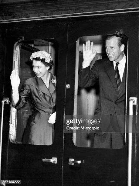 Queen Elizabeth II and Prince Philip visiting, Wales, Pictured, waving out of a train. August 1955.