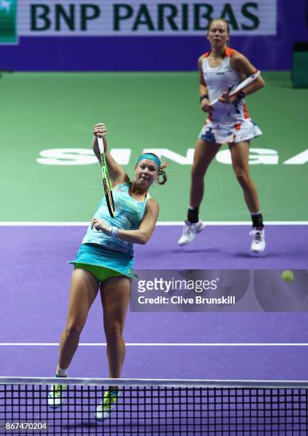 Kiki Bertens of Netherlands and Johanna Larsson of Sweden in action in the doubles semi final match against Elena Vesnina and Ekaterina Makarova of...