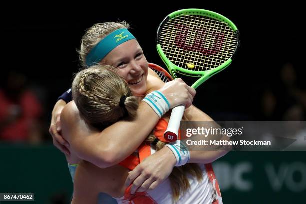 Kiki Bertens of Netherlands and Johanna Larsson of Sweden celebrate victory in the doubles semi final match against Elena Vesnina and Ekaterina...