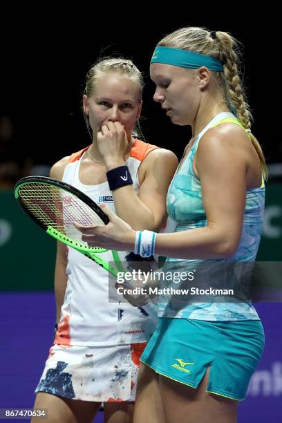 Kiki Bertens of Netherlands and Johanna Larsson of Sweden talk in the doubles semi final match against Elena Vesnina and Ekaterina Makarova of Russia...