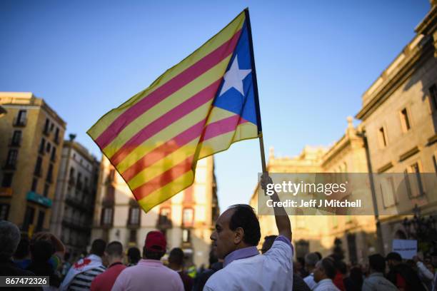 Moroccan Rif activists holds a Catalan independence flag during a demonstration outside the Palau Catalan Regional Government Building on October 28,...