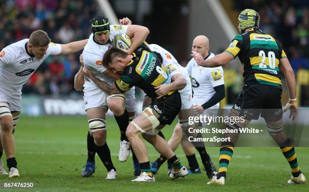 Wasps' James Gaskell is tackled by Northampton Saints' Teimana Harrison during the Aviva Premiership match between Northampton Saints and Wasps at...