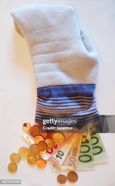 recovering saved money in a sock - change socks stockfoto's en -beelden